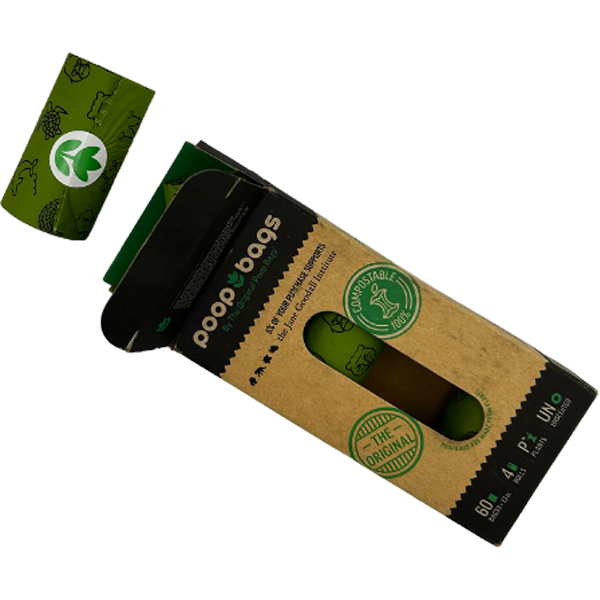 One green poop bag roll outside of open black and brown packaging.