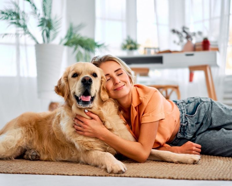 Happy Dog Owner With Dog At Home Happy Dog Owner With Dog At Home